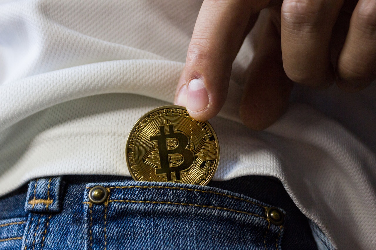 Cryptocurrencies, a coin being put in a pocket